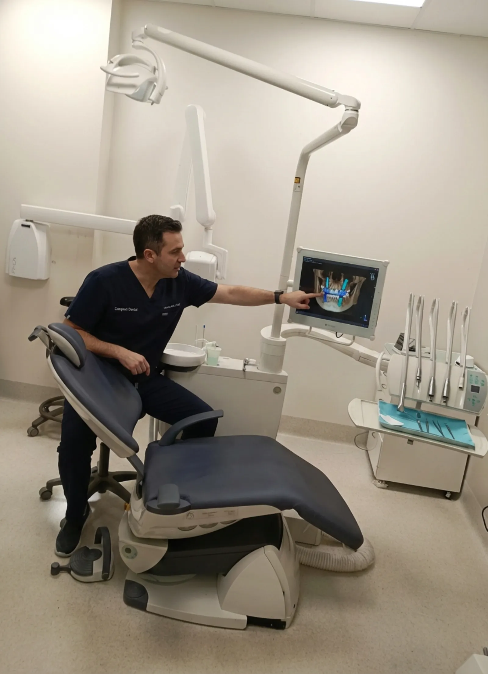 Dentist reviewing dental implant CBCT scan at Compass Dental Care Darwin